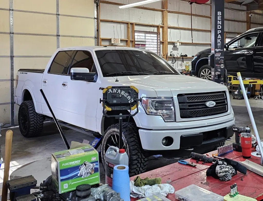 White Ford F-150 in a service bay at Juice Garage